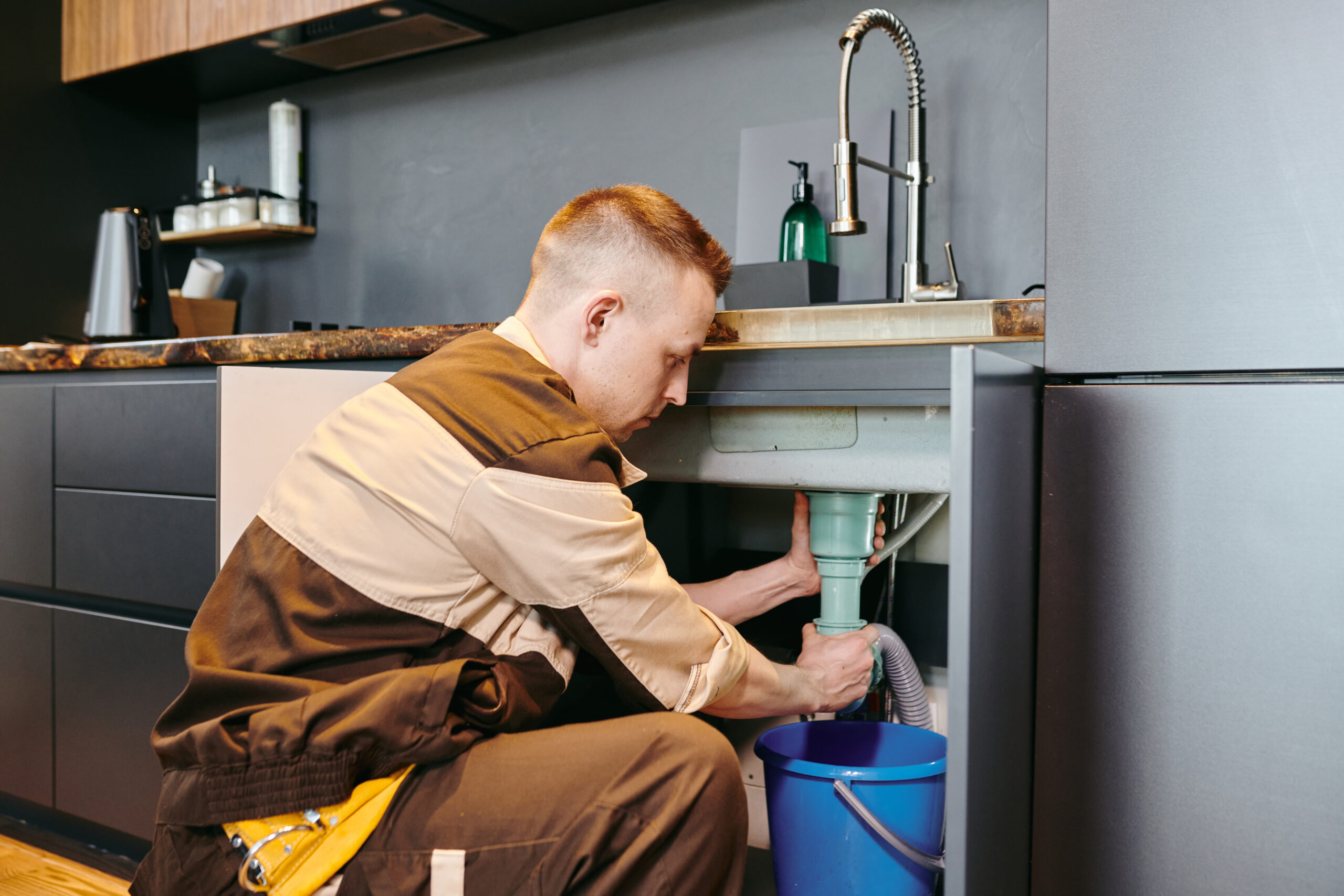 A skilled plumber repairing pipes in Birmingham, ensuring reliable plumbing solutions.
