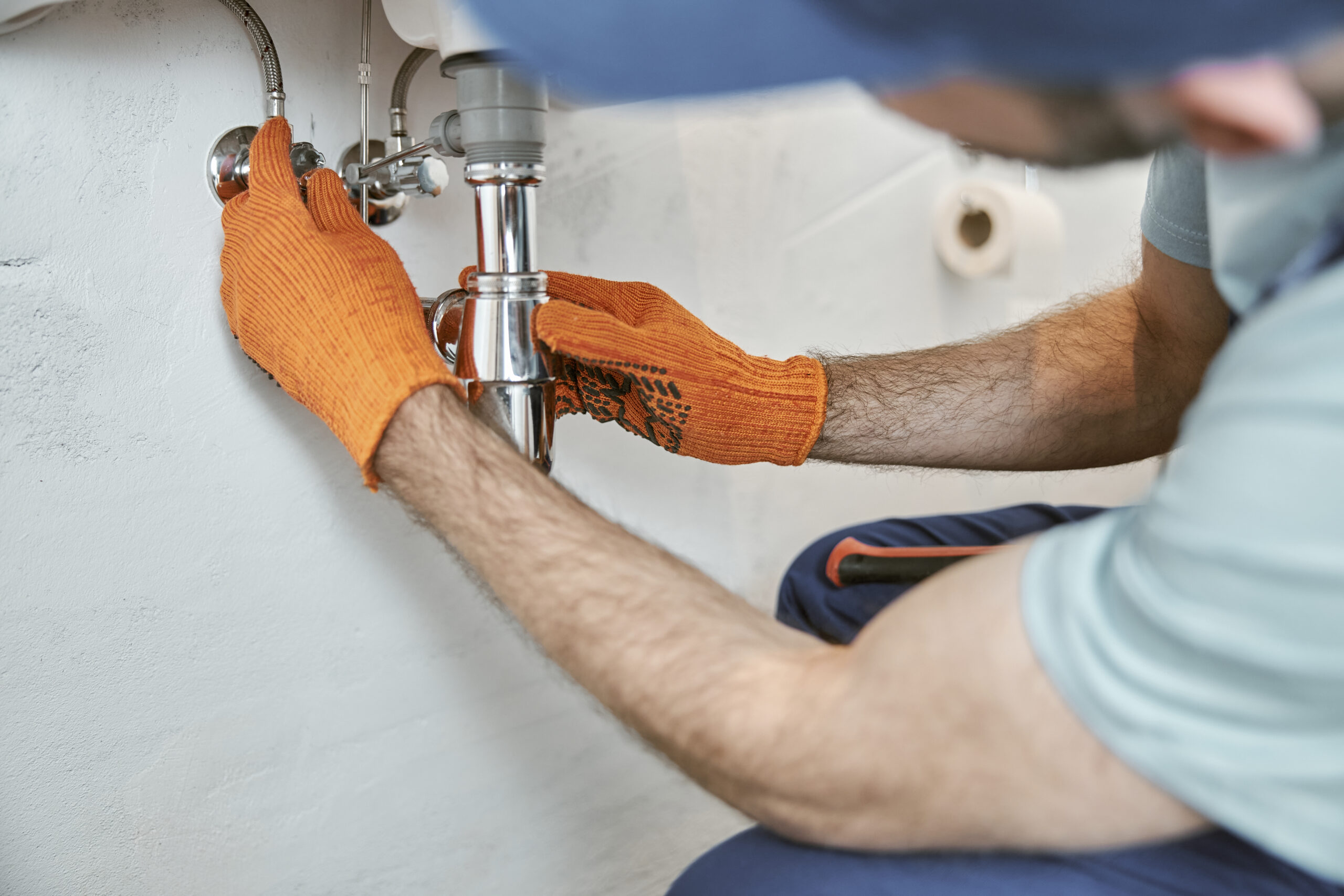 A skilled plumber repairing a leaky pipe in Birmingham