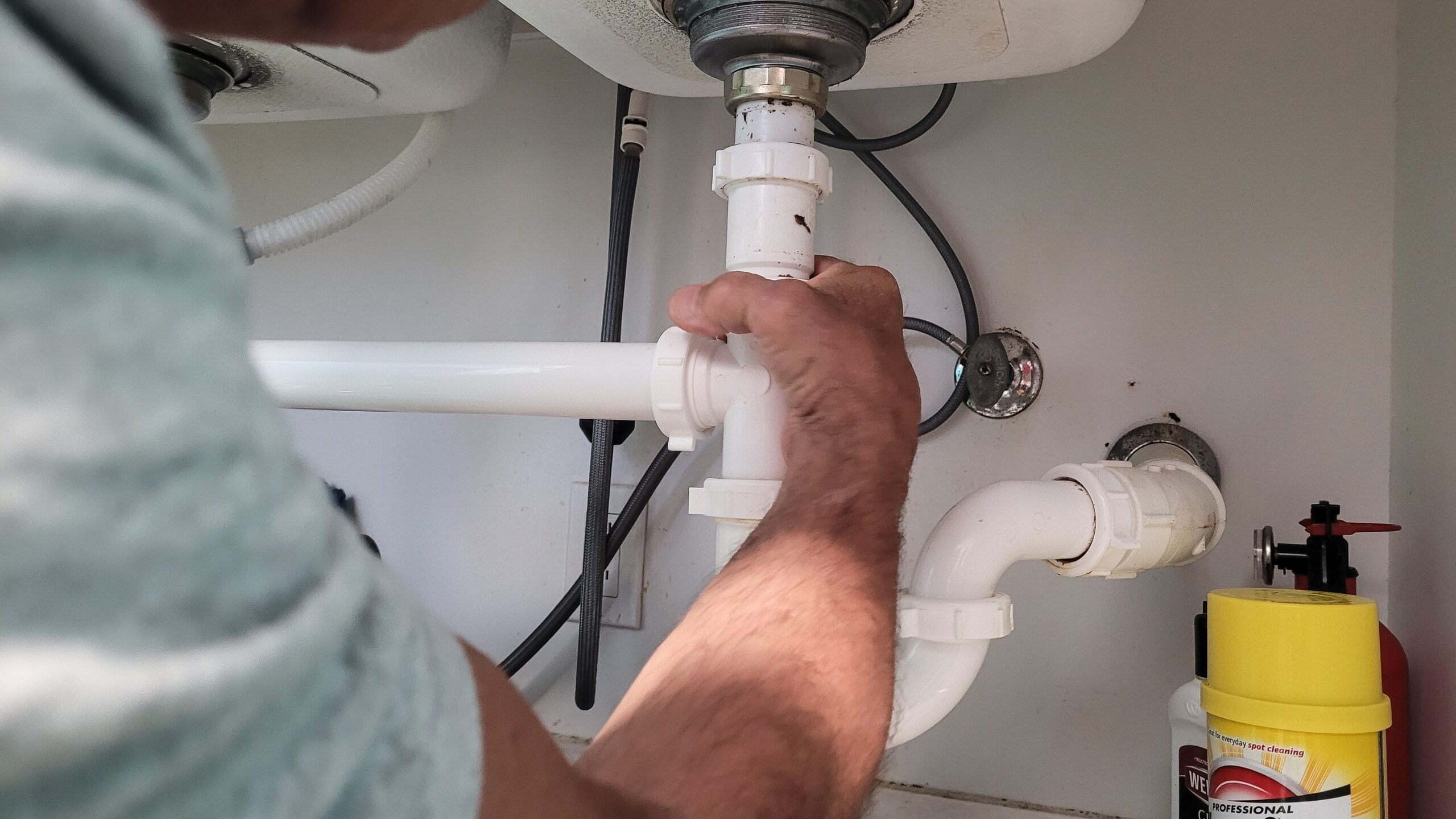 Professional plumber installing new plumbing system with precision.